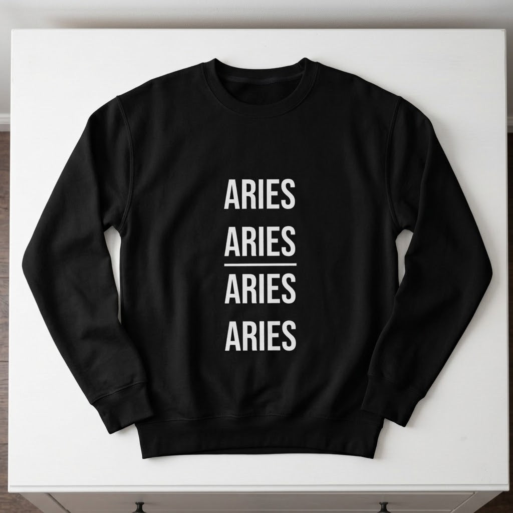 A black crewneck sweatshirt with the word 'ARIES' printed vertically four times in white sans-serif text, separated by a horizontal line on the front, laid flat on a white surface.
