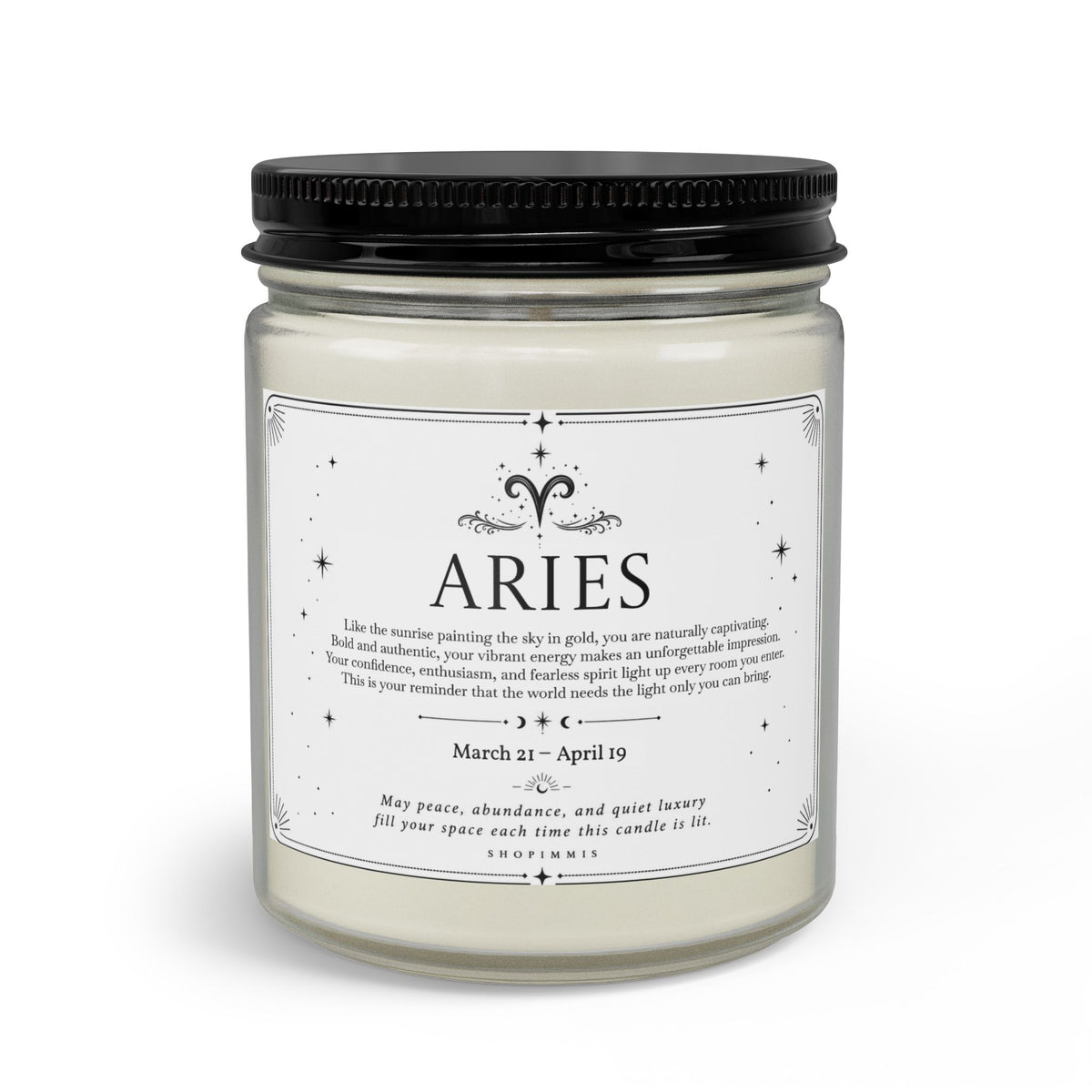 A jar candle with a black metal screw-on lid and a white wax fill, featuring a white label printed with the name 'ARIES' and decorative text, shown on a clean white background.