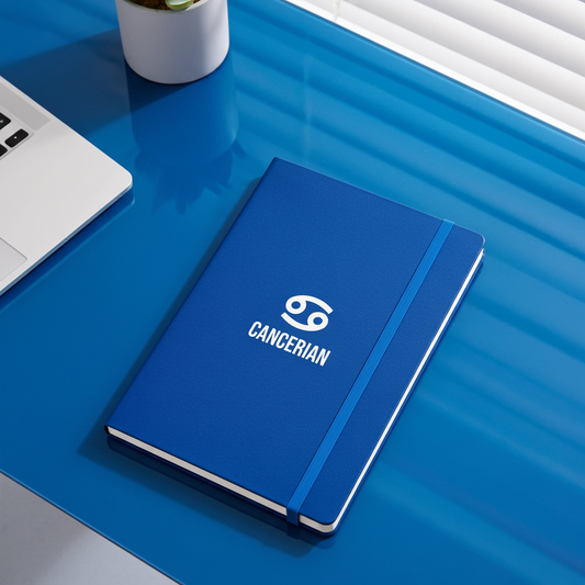 Blue notebook with 'Cancerian' logo on a blue desk
