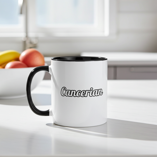 White mug with black handle and 'Cancerian' text on a kitchen counter.