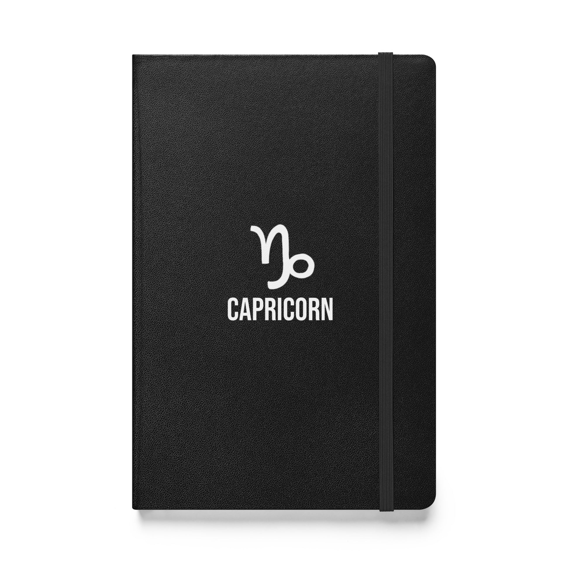 A black hardcover notebook with the Capricorn sign on the cover, featuring a white text label and a simple design.