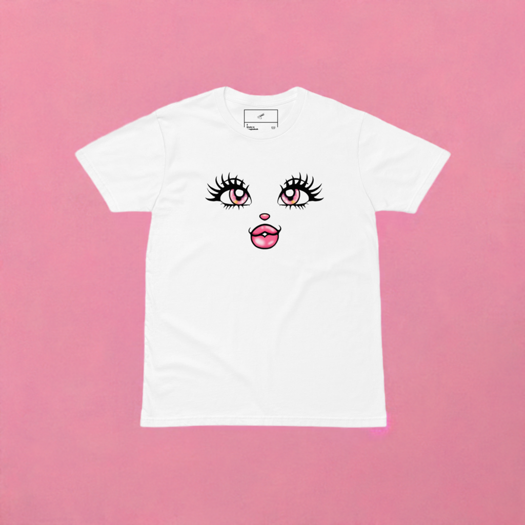 White crew neck t-shirt with a graphic artwork of a stylized face with prominent eyelashes and a pink mouth on the front.
