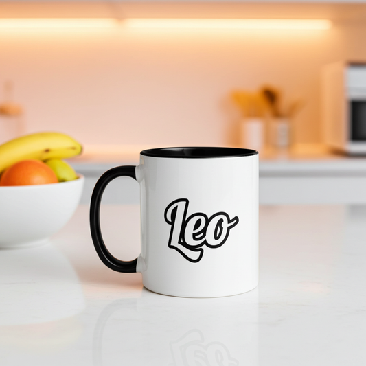 White mug with black interior and handle, featuring 'Leo', on a kitchen counter.