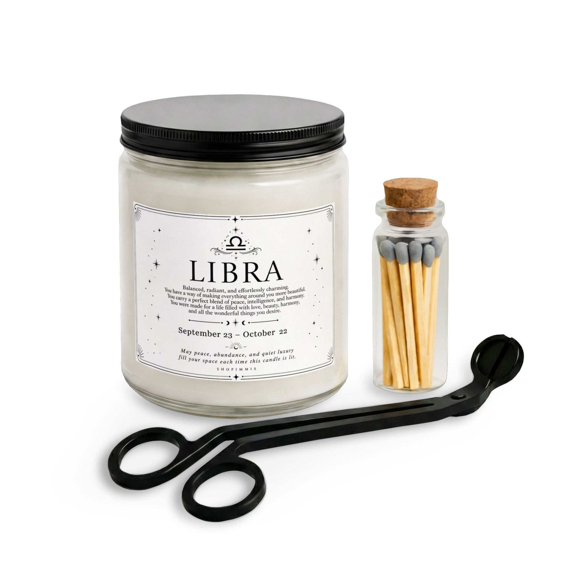 Libra candle with black lid, matches in a small container, and scissors on a white background