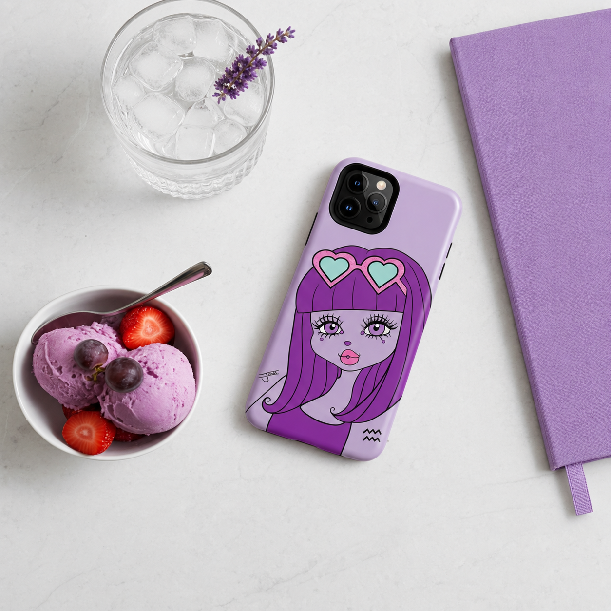 A light purple phone case featuring an Aquarius character design, styled in a flat-lay on a white marble surface with a glass of water, a bowl of ice cream, and a purple notebook.
