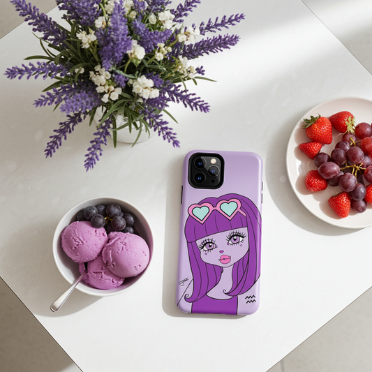 A light purple phone case with an aquarius character design, displayed on a white tabletop next to a bowl of purple ice cream, blueberries, strawberries, and grapes, with a purple flower arrangement in the background.