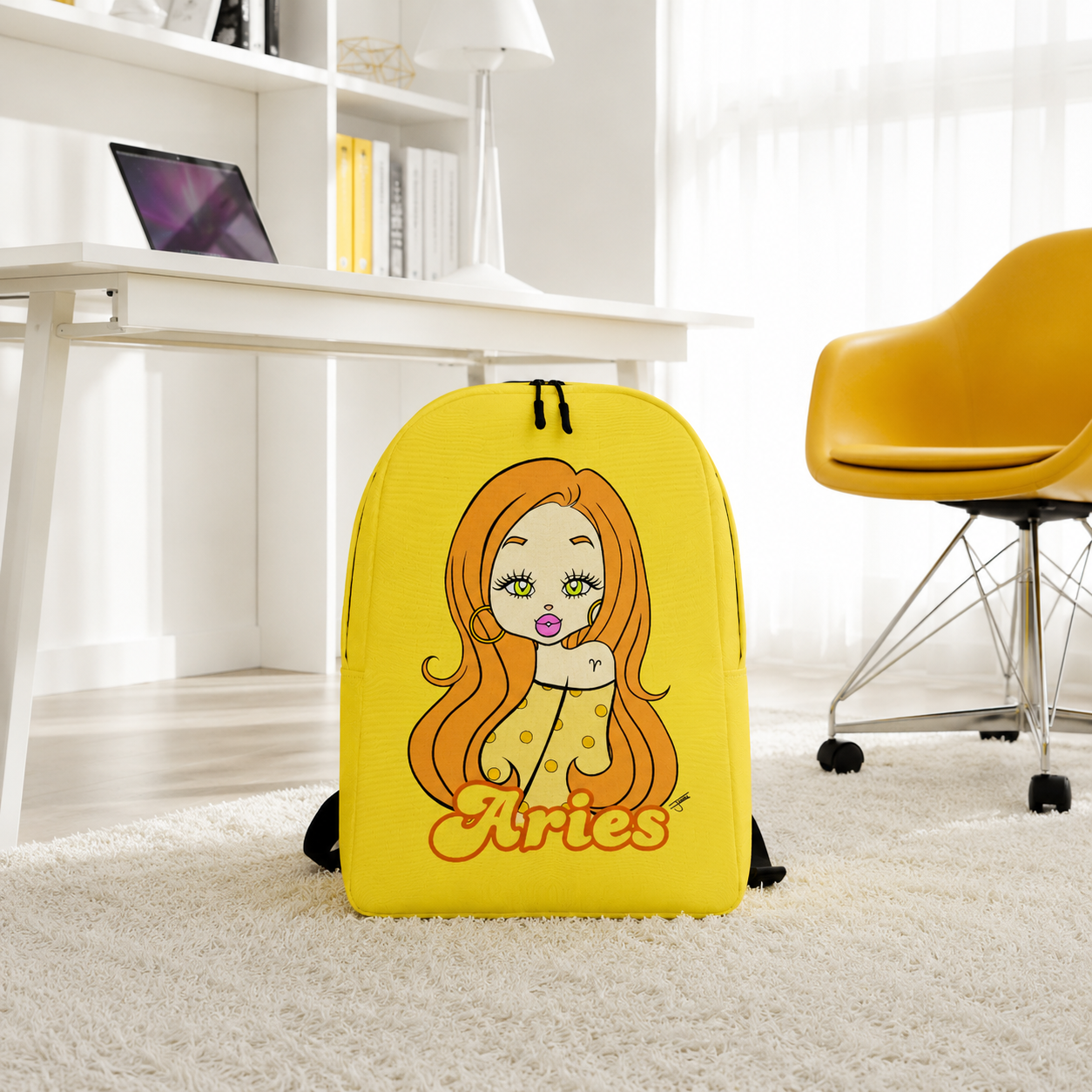 A bright yellow backpack with a cartoon illustration of a woman with long orange hair and the word 'Aries' on the front, standing on a white shag rug in a modern room with a desk, chair, and shelves.