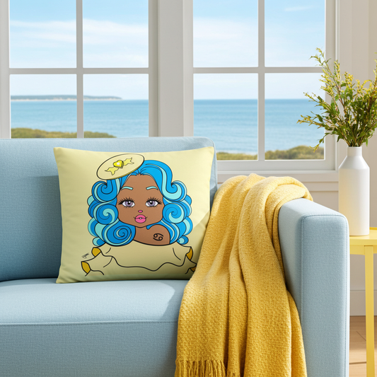 Decorative pillow with a Cancerian character design on a light blue sofa in a room with large windows overlooking a scenic view.