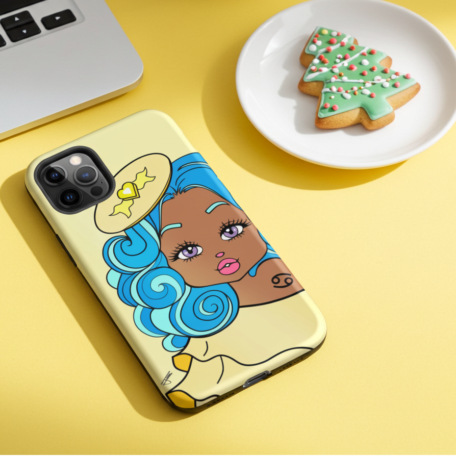 Phone case with cartoon character on a yellow surface with a laptop and cookies.