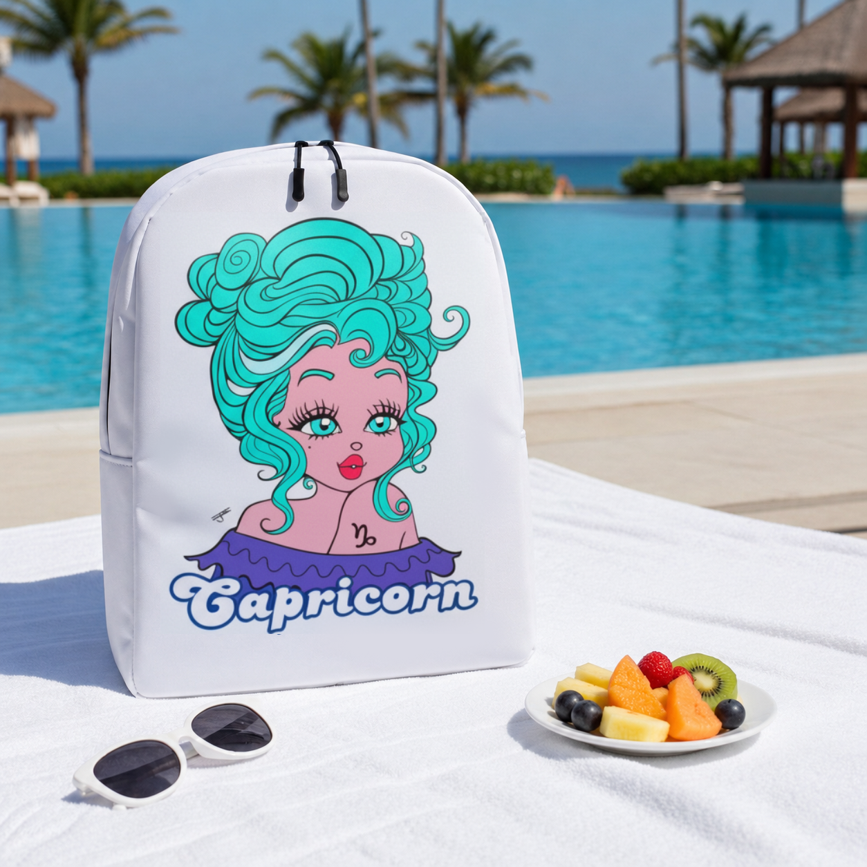 Backpack with Capricorn design by a poolside with fruit plate and sunglasses.