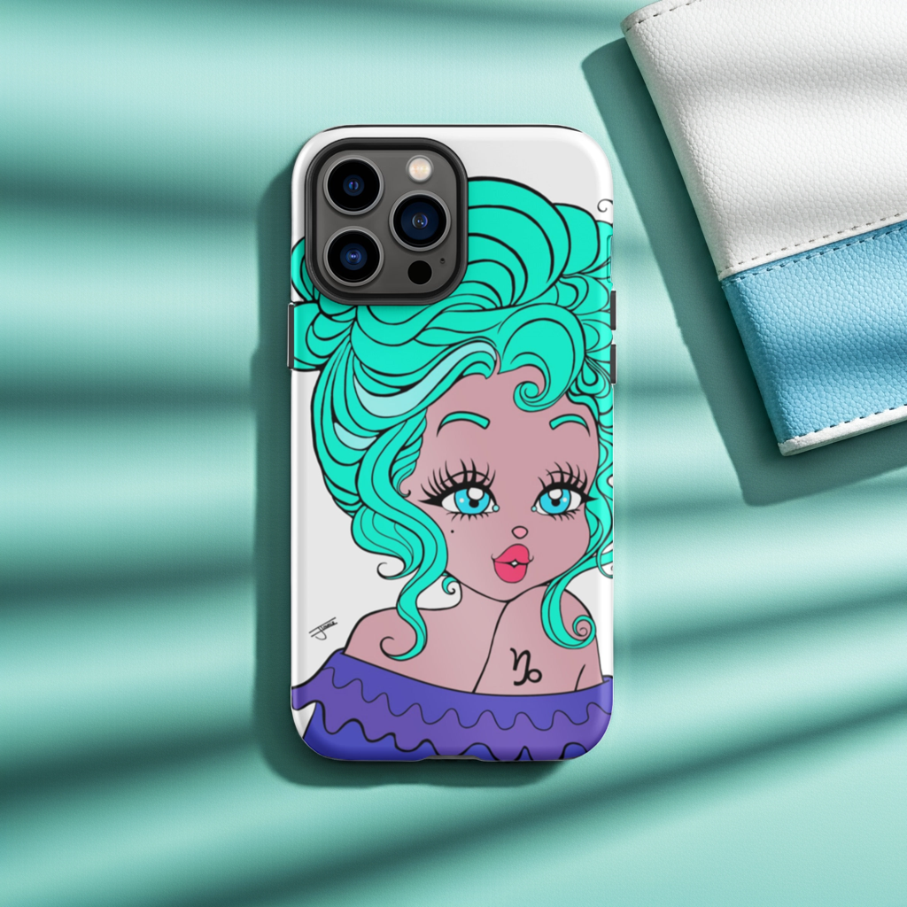 Phone case with Capricorn design on a desk with stationery items