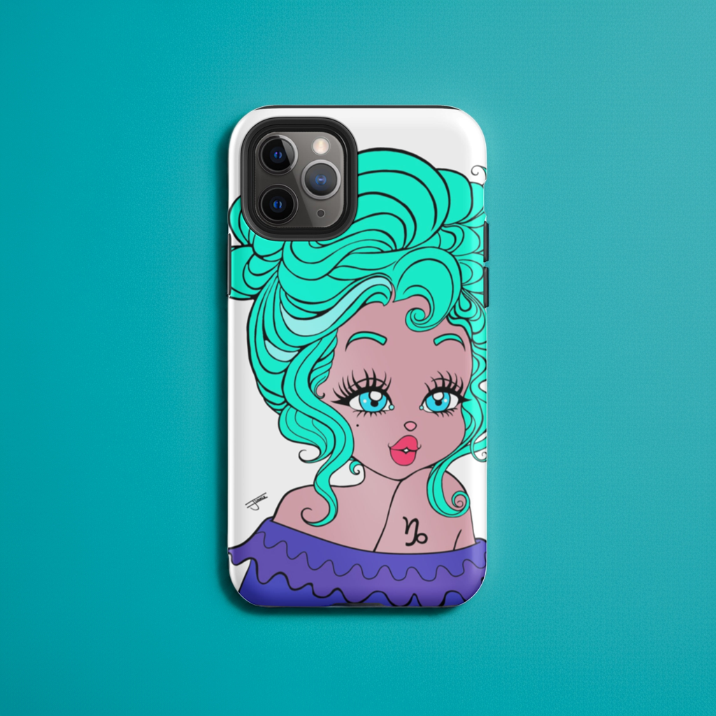 Phone case with Capricorn design on a desk.