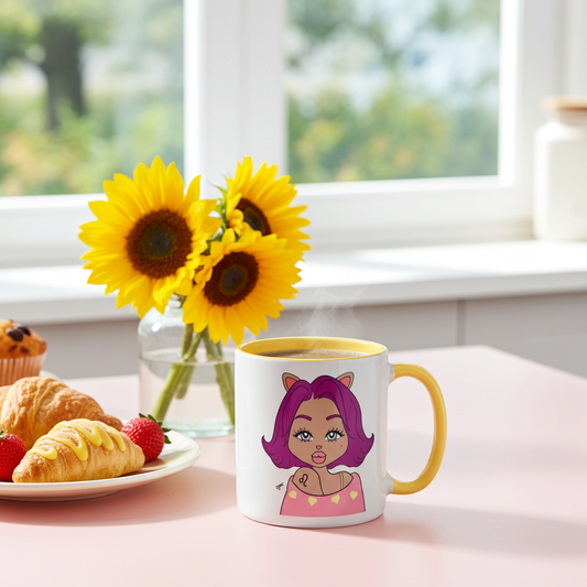A white ceramic mug with a yellow handle and interior, featuring a cartoon illustration of a woman with purple hair and cat ears, set on a pink table next to sunflowers and pastries in a bright kitchen.