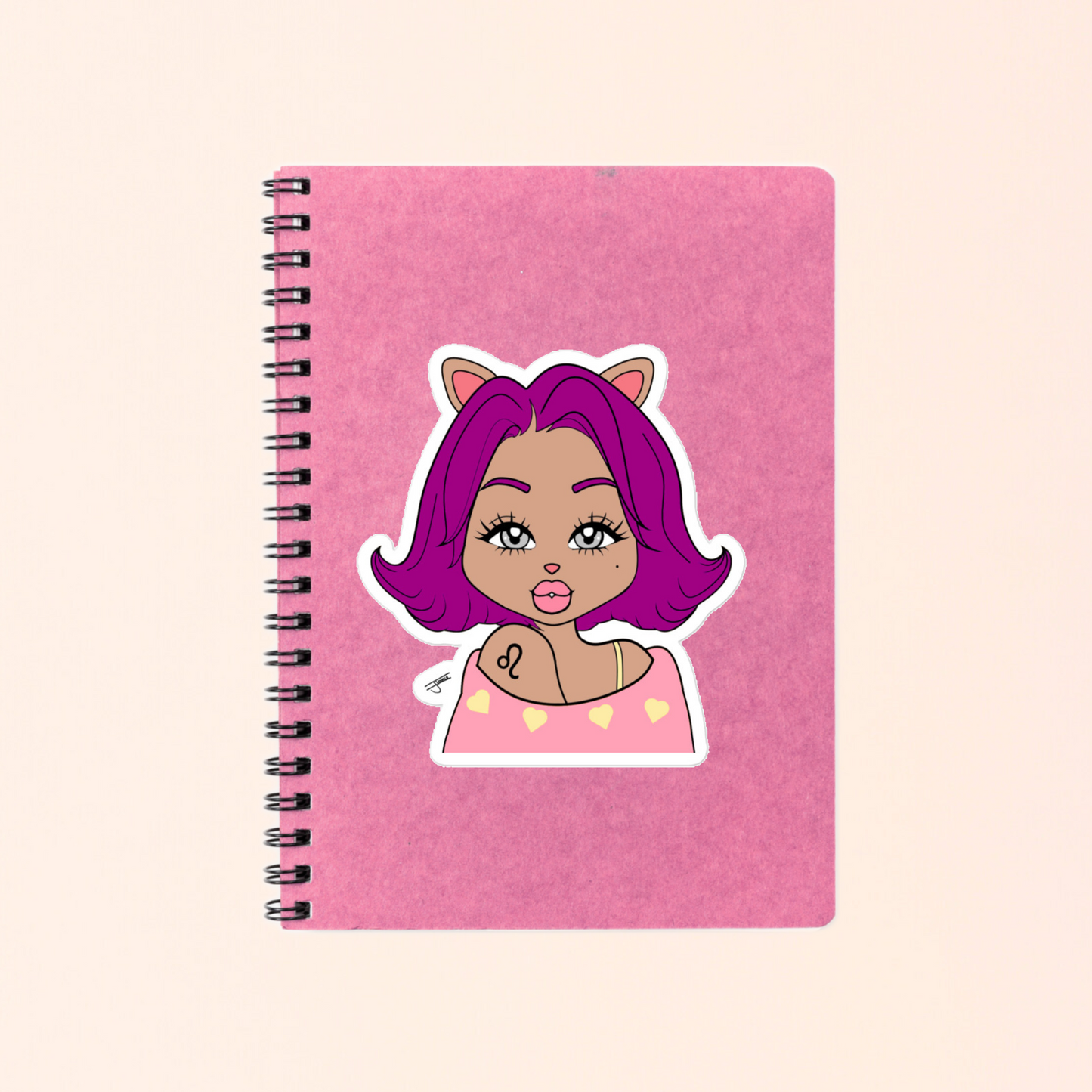 Pink notebook with a Leo character on a beige background