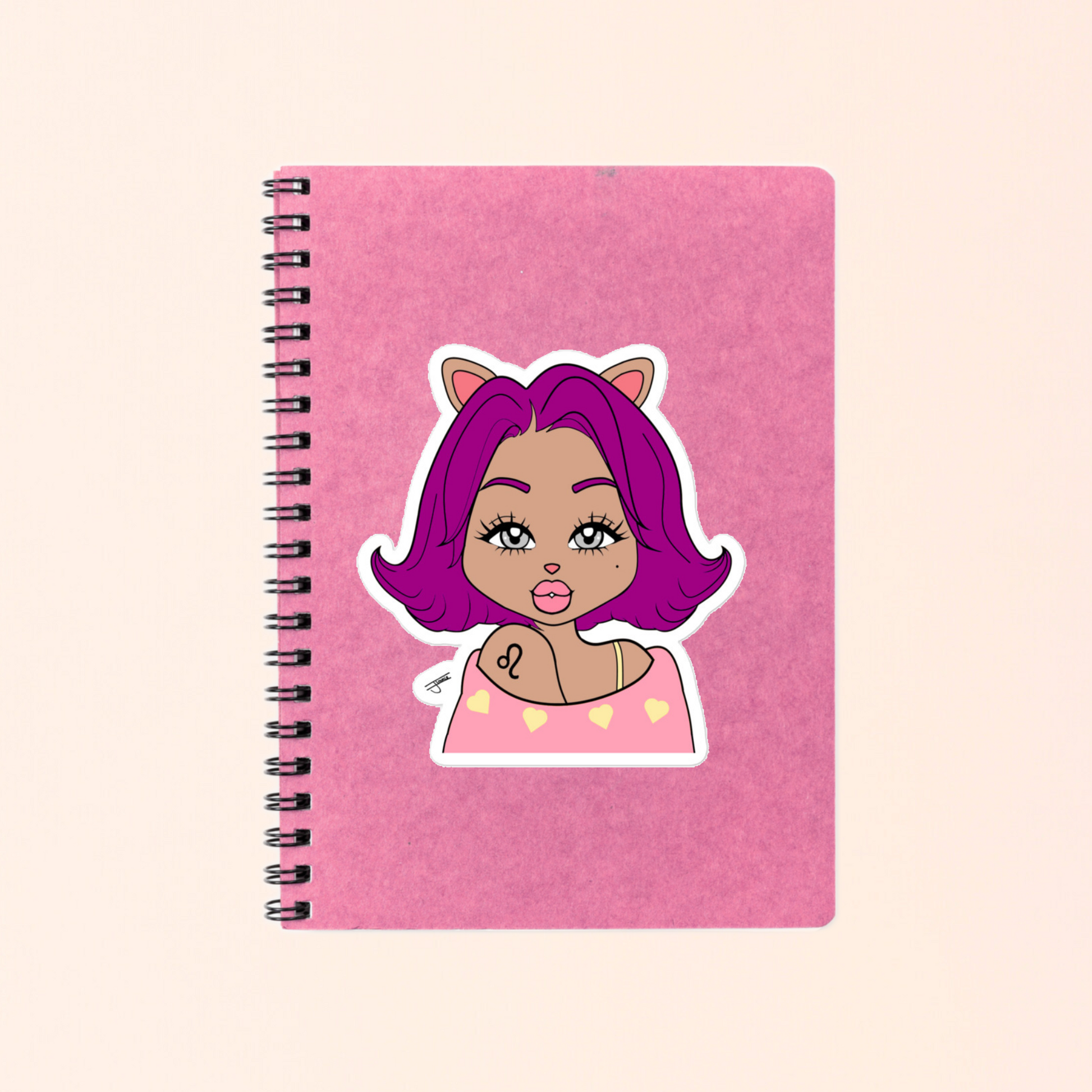 Pink notebook with a Leo character on a beige background