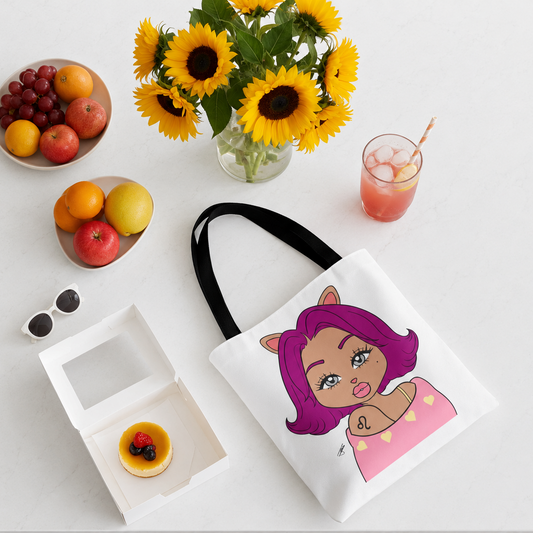 Tote bag with a Leo character design on a table with fruit, flowers, and a drink.