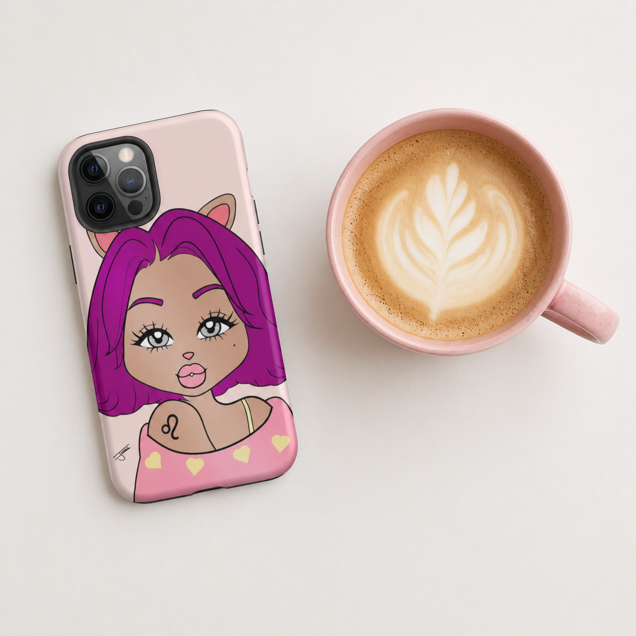 iPhone case with a Leo character design next to a cup of coffee on a light surface