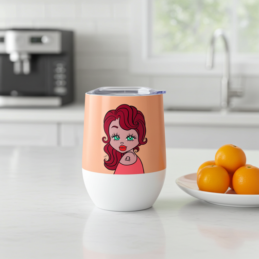 Tumbler with a Libra character on a kitchen counter with oranges