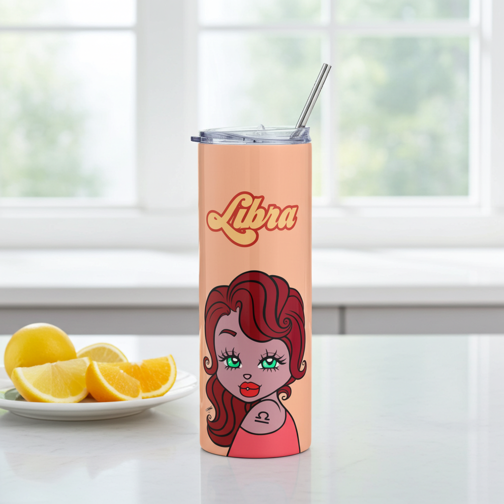 Tumbler with Libra design on a kitchen counter with sliced oranges.