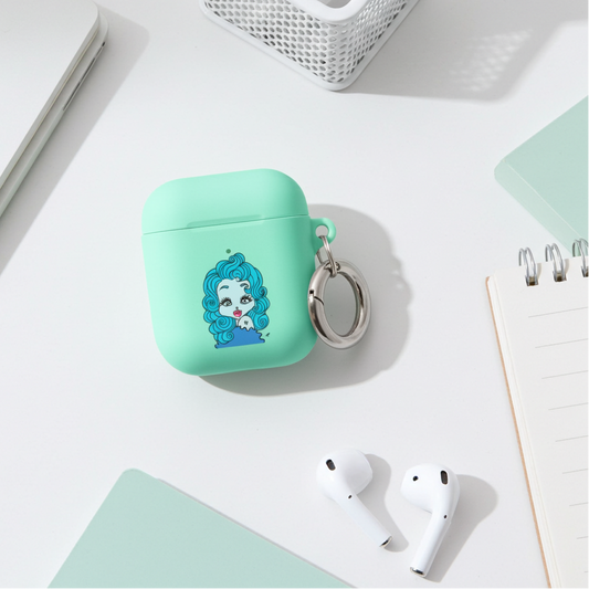 Mint green airpod case with a Pisces character design on a desk with airpods and stationery.
