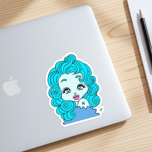 Laptop with a sticker of a Pisces character with blue hair on a wooden surface