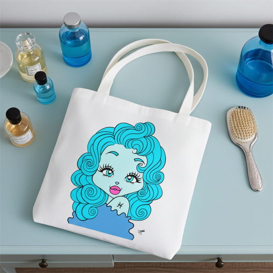White tote bag with a Pisces character on a light blue surface with beauty products.