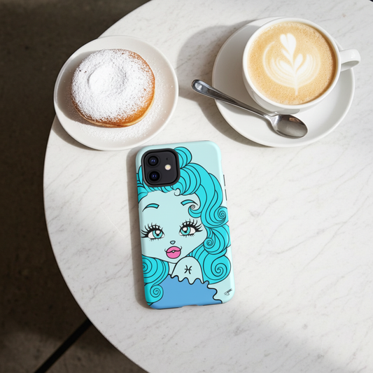 Phone case with a Pisces character design on a table with coffee and a pastry.