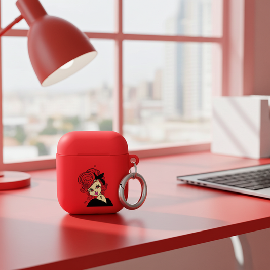 Red air pod case with a Scorpio design on a desk with a laptop and lamp.