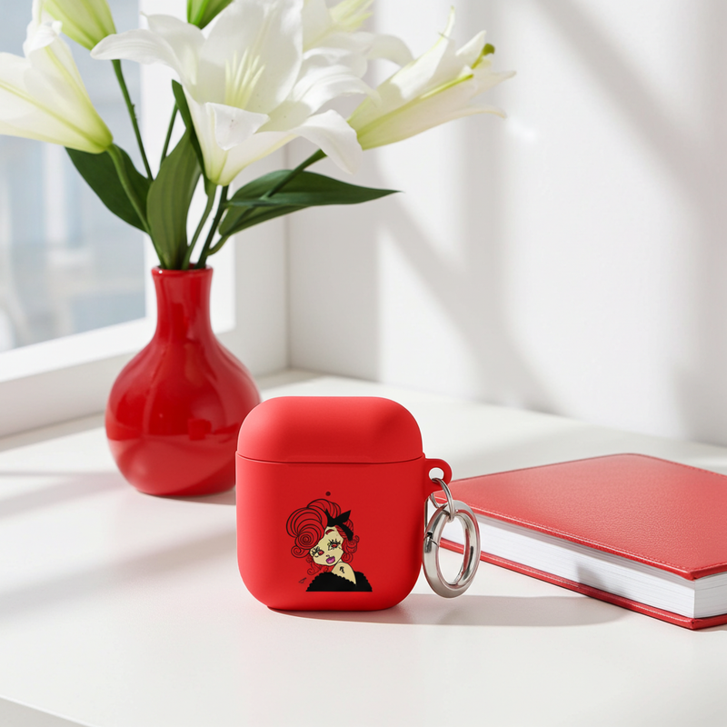 Red air pod case with a Scorpio character design on a white surface with a vase of flowers and notebook in the background