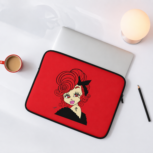 Red laptop sleeve with a scorpio character design on a white surface with a cup and pencil.