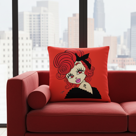 Red pillow with a cartoon character on a red couch in front of a cityscape