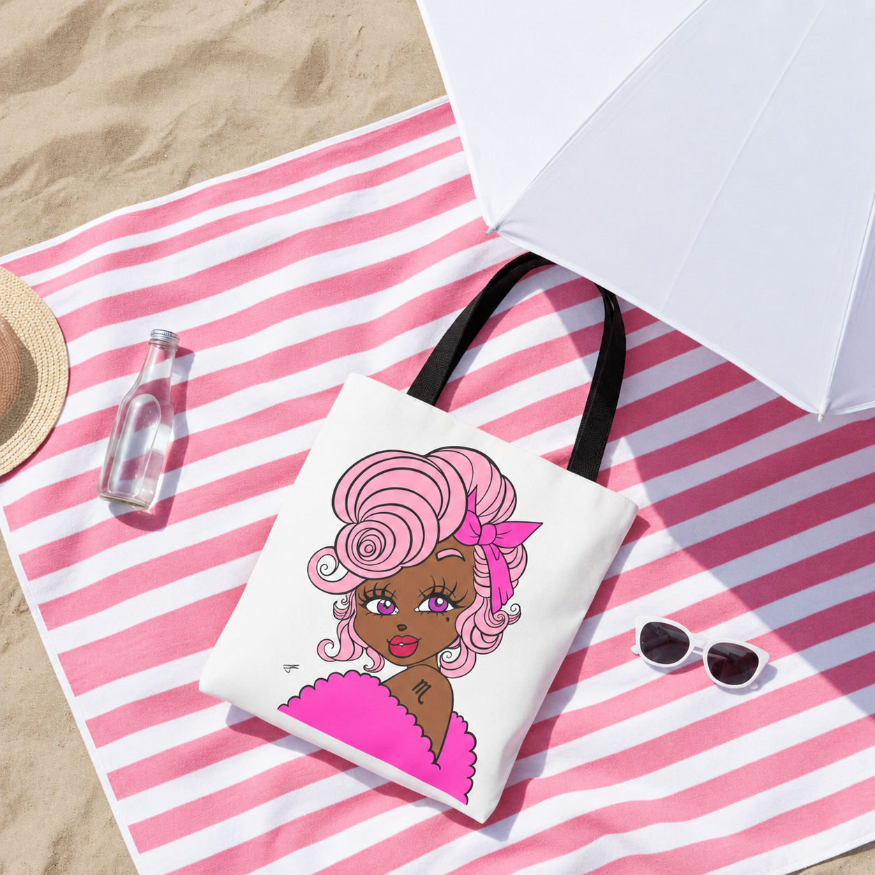 Beach bag with a scorpio character design on a pink and white striped towel with sunglasses and a bottle.