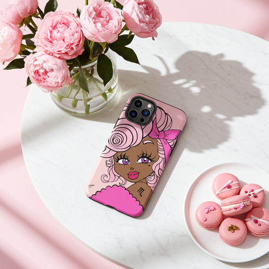 Phone case with a Scorpio character design on a table with pink flowers and macarons.