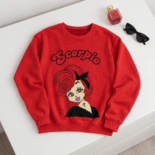 A red crewneck sweatshirt with a retro graphic of a woman with red hair and the word 'Scorpio' in script, styled on a white surface with sunglasses and a perfume bottle.