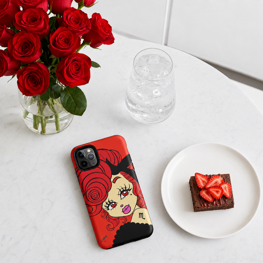 Phone case with a Scorpio character design on a table with red roses and dessert