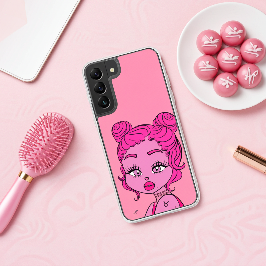 Miss Taurus Samsung Galaxy S22 Phone case on a pink desk next to a pink brush and a plate of pink chocolates.
