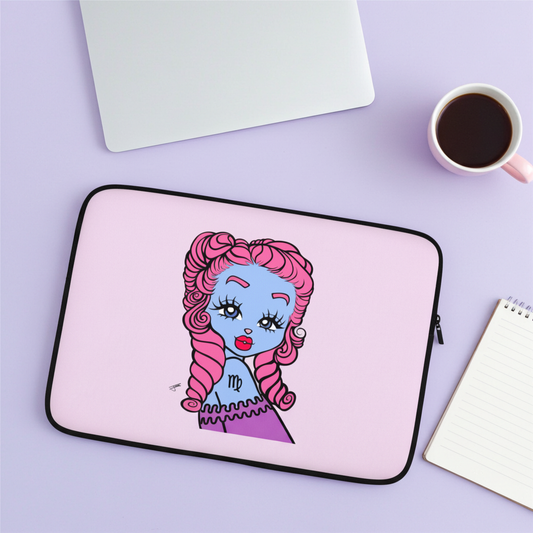 Laptop sleeve with a colorful illustration of a character on a purple surface with a coffee cup and notebook.