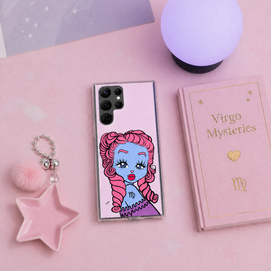 Phone case with a Virgo design on a pink surface with decorative items