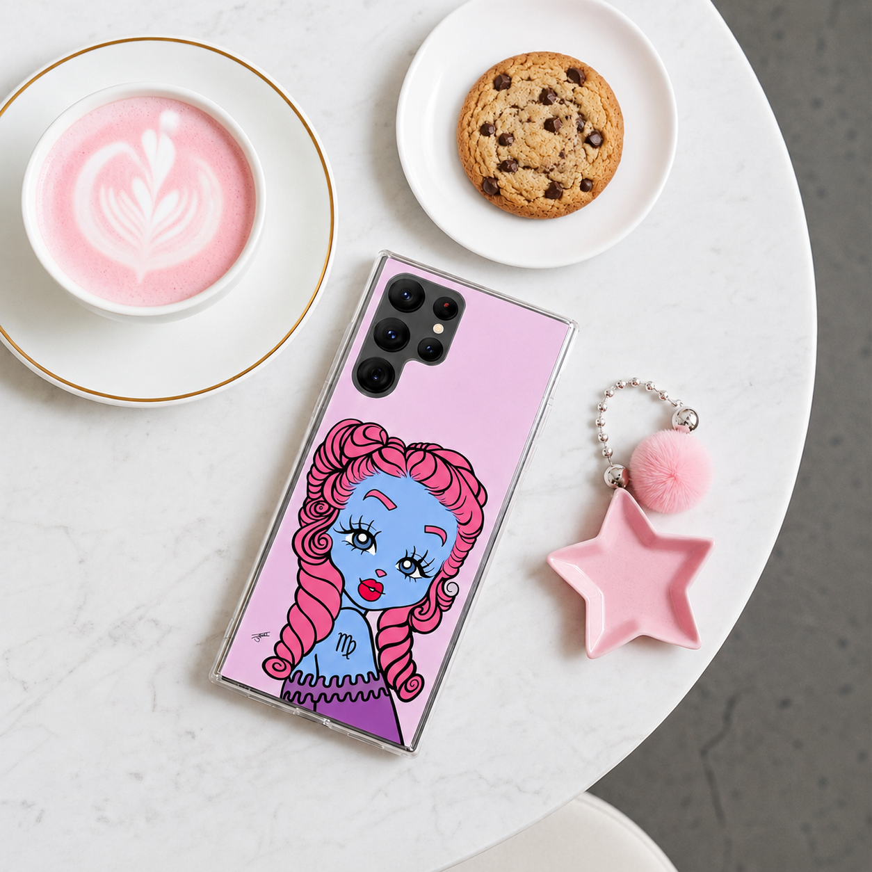 Phone case with a Virgo character design on a table with a cup of coffee and cookie