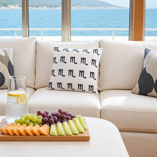 decorative Scorpio pillow on a luxury yacht set against a scenic ocean backdrop.